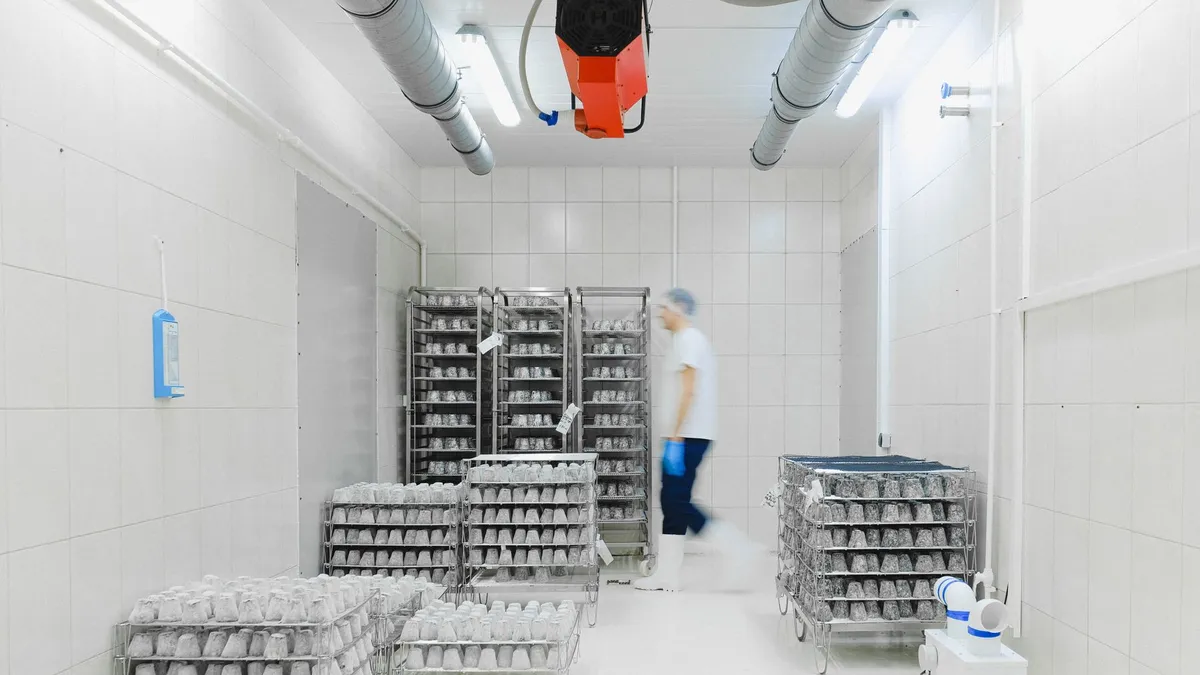 Product racks in a cold room with a white floor