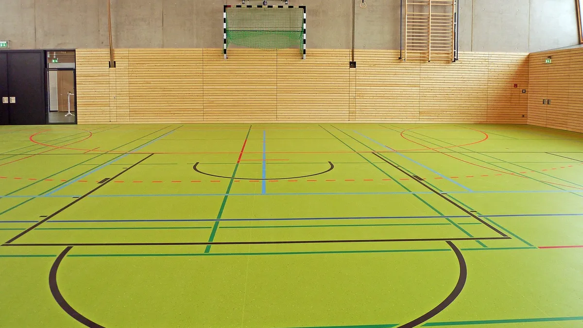 A lined green sports floor in an indoor hall
